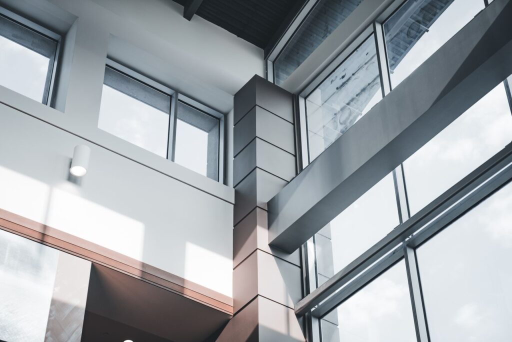 A modern architectural interior focusing on minimalist design and large windows.